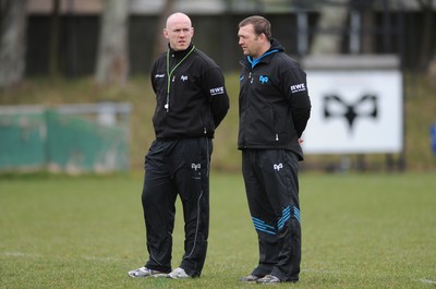 160212 - Ospreys Rugby Training -Ospreys head coach Steve Tandy talks to forwards coach Jonathan Humphreys(R) during training