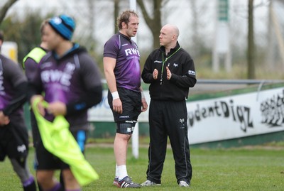 160212 - Ospreys Rugby Training -Ospreys head coach Steve Tandy talks to Alun Wyn Jones(L) during training