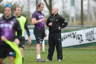 160212 - Ospreys Rugby Training -Ospreys head coach Steve Tandy talks to Alun Wyn Jones(L) during training