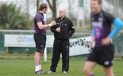 160212 - Ospreys Rugby Training -Ospreys head coach Steve Tandy talks to Alun Wyn Jones(L) during training