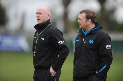 160212 - Ospreys Rugby Training -Ospreys head coach Steve Tandy talks to forwards coach Jonathan Humphreys(R) during training