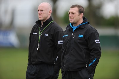 160212 - Ospreys Rugby Training -Ospreys head coach Steve Tandy talks to forwards coach Jonathan Humphreys(R) during training