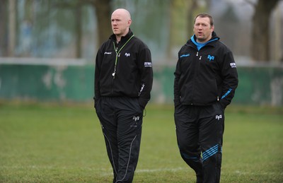 160212 - Ospreys Rugby Training -Ospreys head coach Steve Tandy talks to forwards coach Jonathan Humphreys(R) during training