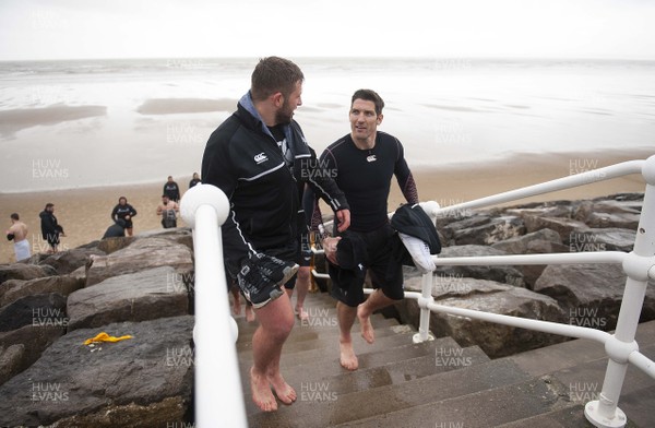 150118 - Ospreys Rugby Sea Recovery - Scott Otten and James Hook after coming out of the sea at Aberavon beach ahead of their qualifying game against Clermont Auvergne