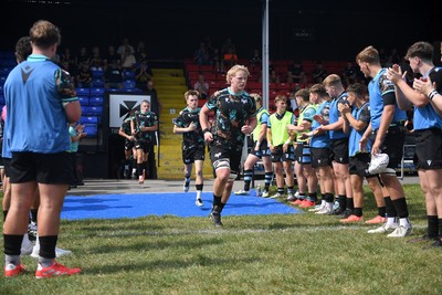 240825 - Ospreys U18s v Cardiff Rugby U18s - Ospreys players run out at the start of the match 