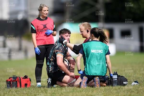 240825 - Ospreys U18s v Cardiff Rugby U18s - Sam Morgan of Ospreys goes down to recieve treatment  
