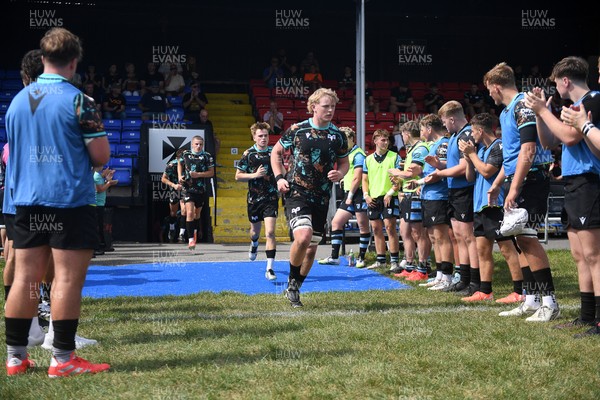 240825 - Ospreys U18s v Cardiff Rugby U18s - Ospreys players run out at the start of the match 