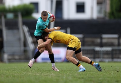 300826 - Ospreys U18s v Dragons U18s - RAG - Dylan Quin of Ospreys is tackled by George Bradbury of Dragons 