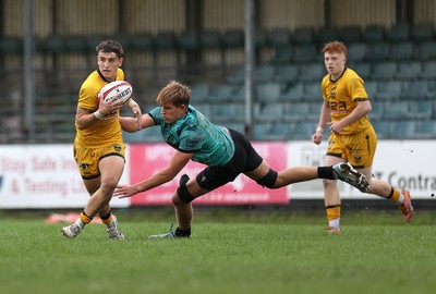 300826 - Ospreys U18s v Dragons U18s - RAG - Liam Lawlor of Dragons is tackled by Jacob Jones of Ospreys 