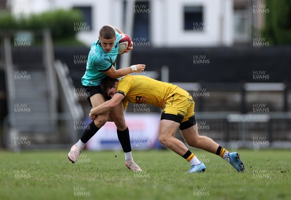 300826 - Ospreys U18s v Dragons U18s - RAG - Dylan Quin of Ospreys is tackled by George Bradbury of Dragons 