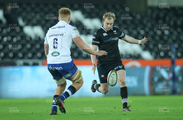 020218 - Ospreys v Bath Rugby, Anglo Welsh Cup - Luke Price of Ospreys kicks the ball past Miles Reid of Bath