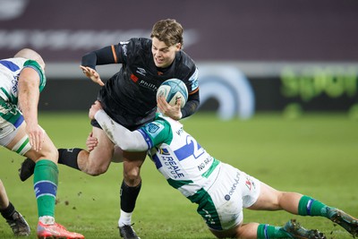 040323 - Ospreys v Benetton - United Rugby Championship - Jack Walsh of Ospreys is tackled by Bautista Bernasconi of Benetton