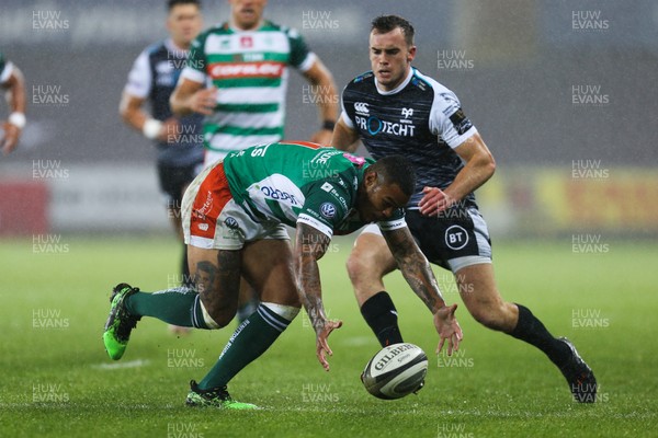 121019 - Ospreys v Benetton Rugby Treviso, Guinness PRO14 - Cai Evans of Ospreys puts Monty Ioane of Benetton Rugby under pressure as he collects the ball