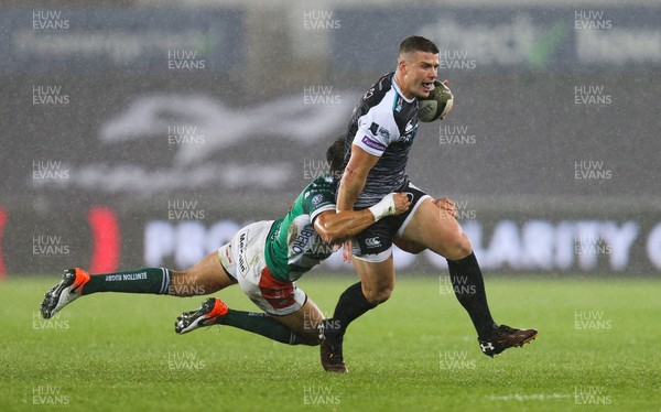 121019 - Ospreys v Benetton Rugby Treviso, Guinness PRO14 - Scott Williams of Ospreys is tackled by Ignacio Brex of Benetton Rugby