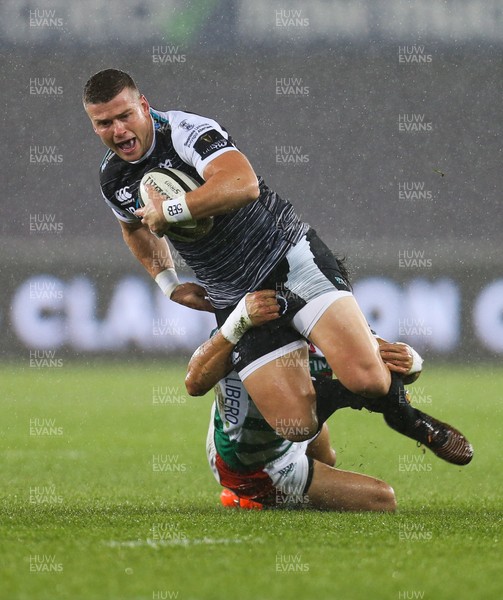 121019 - Ospreys v Benetton Rugby Treviso, Guinness PRO14 - Scott Williams of Ospreys is tackled by Ignacio Brex of Benetton Rugby