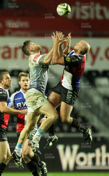 151113 - Ospreys v Cardiff Blues - LV= Cup - Gavin Evans of Cardiff Blues and Jamie Murphy of Ospreys go up for the ball