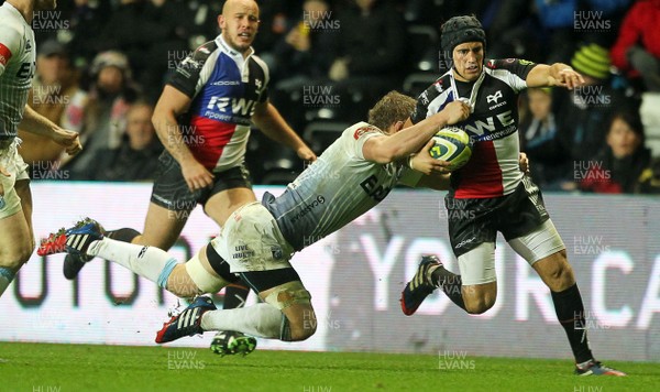 151113 - Ospreys v Cardiff Blues - LV= Cup - Matthew Morgan of Ospreys is tackled by Thomas Young of Cardiff Blues