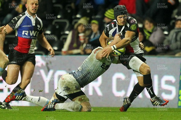 151113 - Ospreys v Cardiff Blues - LV= Cup - Matthew Morgan of Ospreys is tackled by Thomas Young of Cardiff Blues