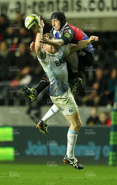 151113 - Ospreys v Cardiff Blues - LV= Cup - Gavin Evans of Cardiff Blues and Rhys Webb of Ospreys go up for the ball