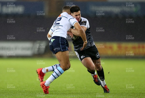 211219 - Ospreys v Cardiff Blues - Guinness PRO14 - Tiaan Thomas-Wheeler of Ospreys is tackled by Ben Thomas of Cardiff Blues