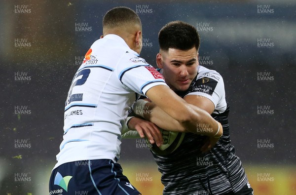 211219 - Ospreys v Cardiff Blues - Guinness PRO14 - Tiaan Thomas-Wheeler of Ospreys is tackled by Ben Thomas of Cardiff Blues