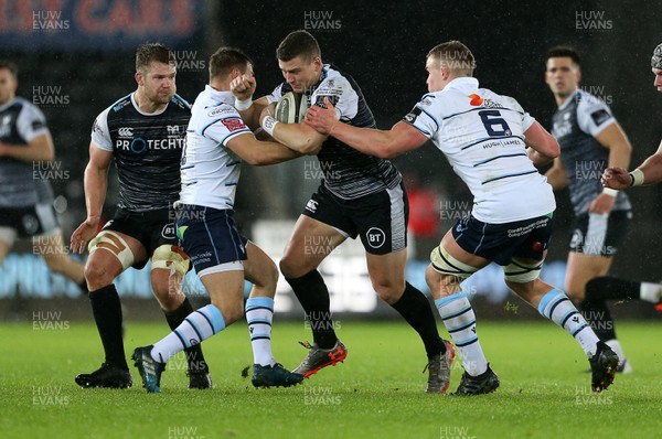 211219 - Ospreys v Cardiff Blues - Guinness PRO14 - Scott Williams of Ospreys is tackled by Jarrod Evans and Shane Lewis-Hughes of Cardiff Blues