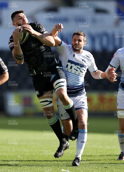 240421 - Ospreys v Cardiff Blues - Rainbow Cup - Rhys Davies of Ospreys is challenged by Jason Tovey of Cardiff Blues 