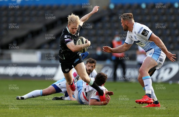 240421 - Ospreys v Cardiff Blues - Rainbow Cup - Mat Protheroe of Ospreys is tackled by Gwilym Bradley of Cardiff Blues
