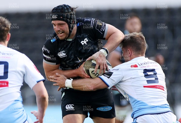 240421 - Ospreys v Cardiff Blues - Rainbow Cup - Dan Evans of Ospreys is tackled by Lewis Jones of Cardiff Blues