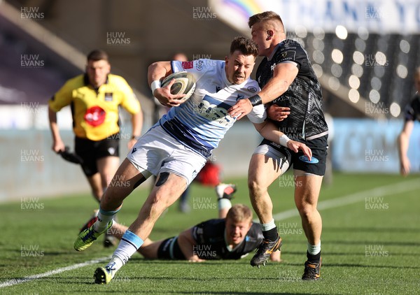 240421 - Ospreys v Cardiff Blues - Rainbow Cup - Jason Harries of Cardiff Blues is tackled by Ifan Phillips of Ospreys