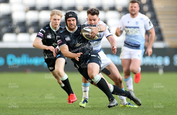 240421 - Ospreys v Cardiff Blues - Rainbow Cup - Dan Evans of Ospreys is tackled by Jason Harries of Cardiff Blues