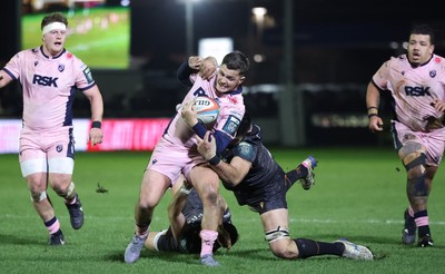 010126 - Ospreys v Cardiff Rugby, United Rugby Championship - Callum Sheedy of Cardiff Rugby is tackled short of the line by Rhys Davies of Ospreys