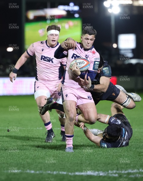010126 - Ospreys v Cardiff Rugby, United Rugby Championship - Callum Sheedy of Cardiff Rugby is tackled short of the line by Rhys Davies of Ospreys