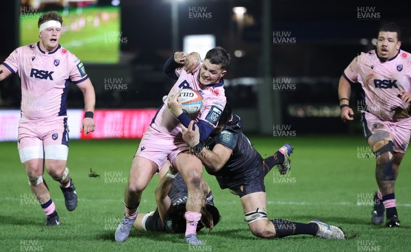 010126 - Ospreys v Cardiff Rugby, United Rugby Championship - Callum Sheedy of Cardiff Rugby is tackled short of the line by Rhys Davies of Ospreys