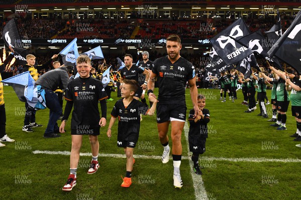 220423 - Ospreys v Cardiff - United Rugby Championship - Rhys Webb of Ospreys leads out his side with his sons on his 200th Ospreys game