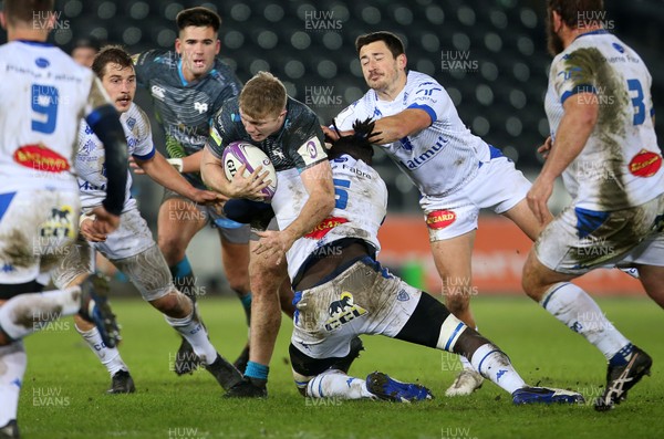 121220 - Ospreys v Castres Olympique - European Challenge Cup - Kieran Williams of Ospreys is tackled by Stephane Onambele Mbarga of Castres