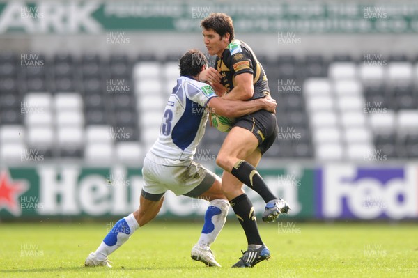 18.10.09 - Ospreys v ASM Clermont Auvergne - Heineken Cup - James Hook of Ospreys is tackled by Gonzalo Canale of Clermont Auvergne. 