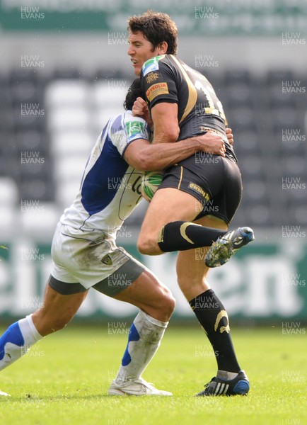 18.10.09 - Ospreys v ASM Clermont Auvergne - Heineken Cup - James Hook of Ospreys is tackled by Gonzalo Canale of Clermont Auvergne. 