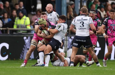 071225 - Ospreys v Connacht - European Challenge Cup - Harri Deaves of Ospreys is tackled by Dave Heffernan of Connacht 