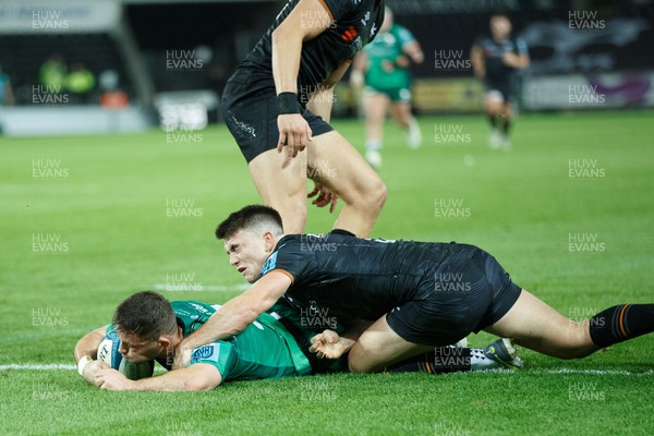 291022 - Ospreys v Connacht - United Rugby Championship - Caolin Blade of Connacht scores a try despite the attention of Reuben Morgan Williams of Ospreys