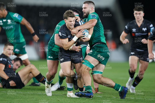 291022 - Ospreys v Connacht - United Rugby Championship - Jack Walsh of Ospreys is tackled by Shamus Hurley-Langton of Connacht