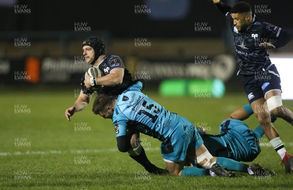 060321 Ospreys v Dragons, Guinness PRO14 - Dan Evans of Ospreys is tackled by Josh Lewis of Dragons and Ashton Hewitt of Dragons