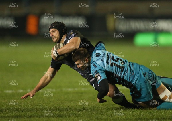 060321 Ospreys v Dragons, Guinness PRO14 - Dan Evans of Ospreys is tackled by Josh Lewis of Dragons and Ashton Hewitt of Dragons