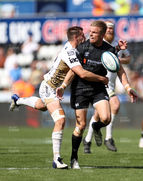 080522 - Ospreys v Dragons - United Rugby Championship - Gareth Anscombe of Ospreys is tackled by Josh Lewis of Dragons