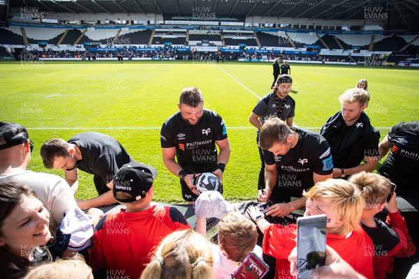 080522 - Ospreys v Dragons - United Rugby Championship - Sam Parry of Ospreys signs autographs
