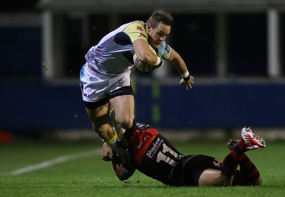 141114 -  Ospreys v Newport Gwent Dragons, LV= Cup, Brewery Field, Bridgend - Ospreys' Hanno Dirksen is tackled by Dragons' Ashton Hewitt