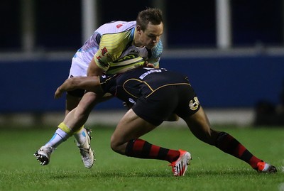 141114 -  Ospreys v Newport Gwent Dragons, LV= Cup, Brewery Field, Bridgend - Ospreys' Hanno Dirksen is tackled by Dragons' Ashton Hewitt