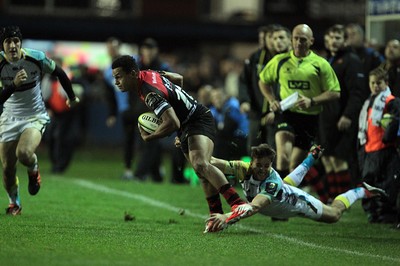 141114 -  Ospreys v Newport Gwent Dragons, LV= Cup, Brewery Field, Bridgend - Ashton Hewitt breaks an Ospreys tackle