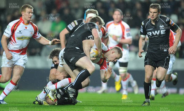 220313 -  Ospreys v Newport-Gwent Dragons - RaboDirect PRO12 -Jack Dixon of Newport-Gwent Dragons is tackled by Jonathan Spratt and Ashley Beck of Ospreys 