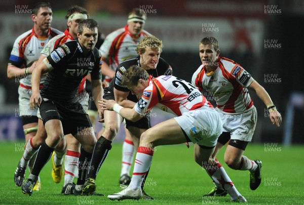 220313 -  Ospreys v Newport-Gwent Dragons - RaboDirect PRO12 -Ben John of Ospreys is tackled by Hallam Amos of Newport-Gwent Dragons 